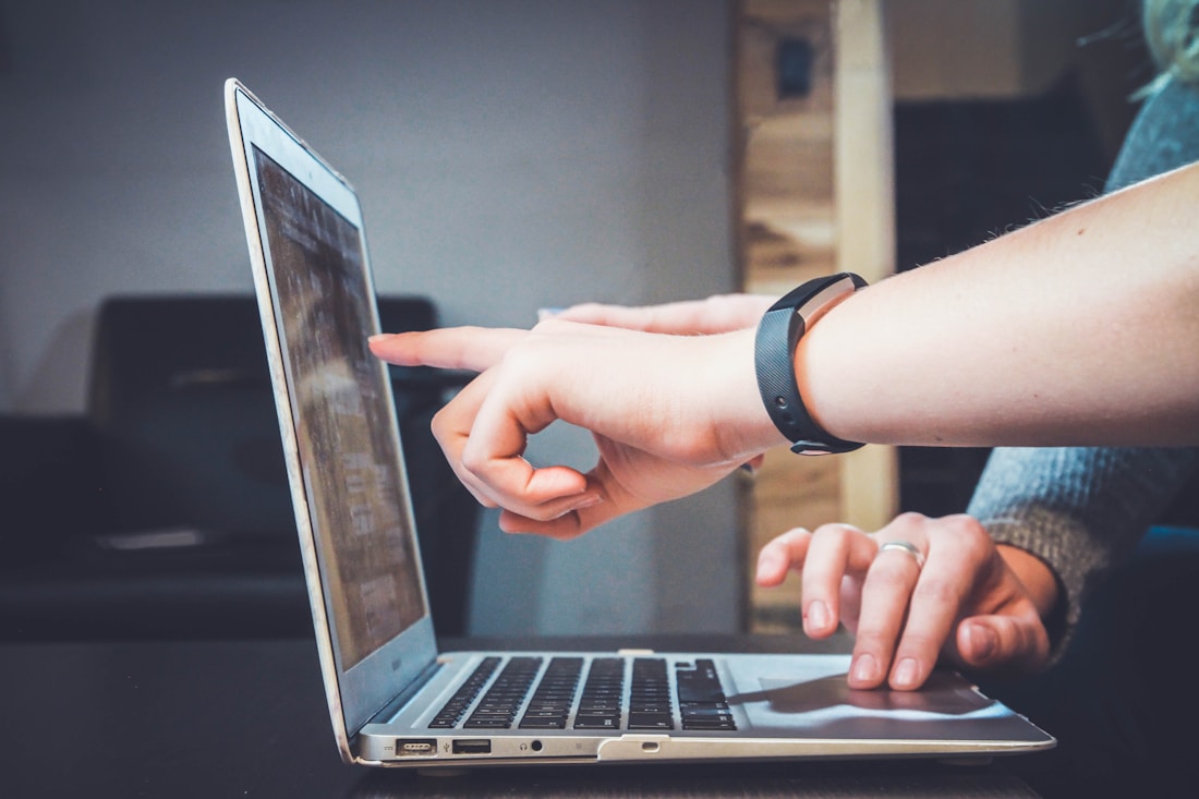 People reviewing information together at a laptop